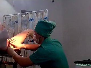 A young young lady in white socks on a gynecological chair